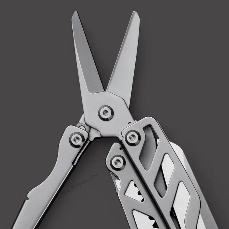 Close-up of the stainless steel blades of a multifunctional folding knife, highlighting its sleek design.